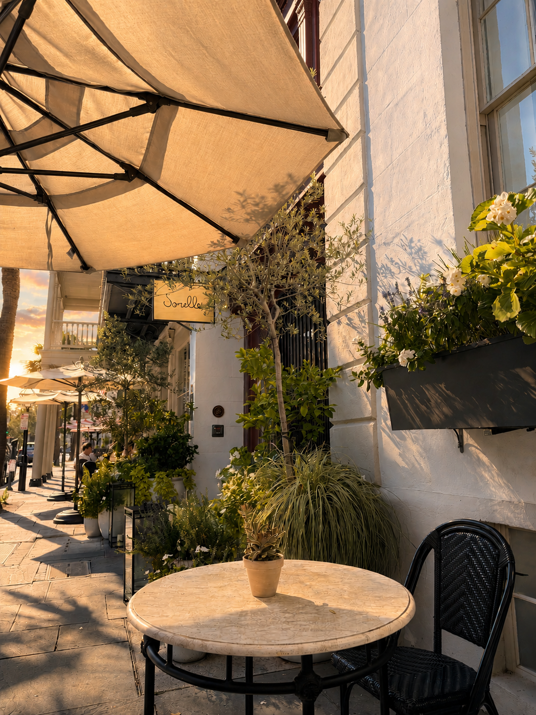 Charming outdoor café table on a historic Charleston sidewalk at golden hour