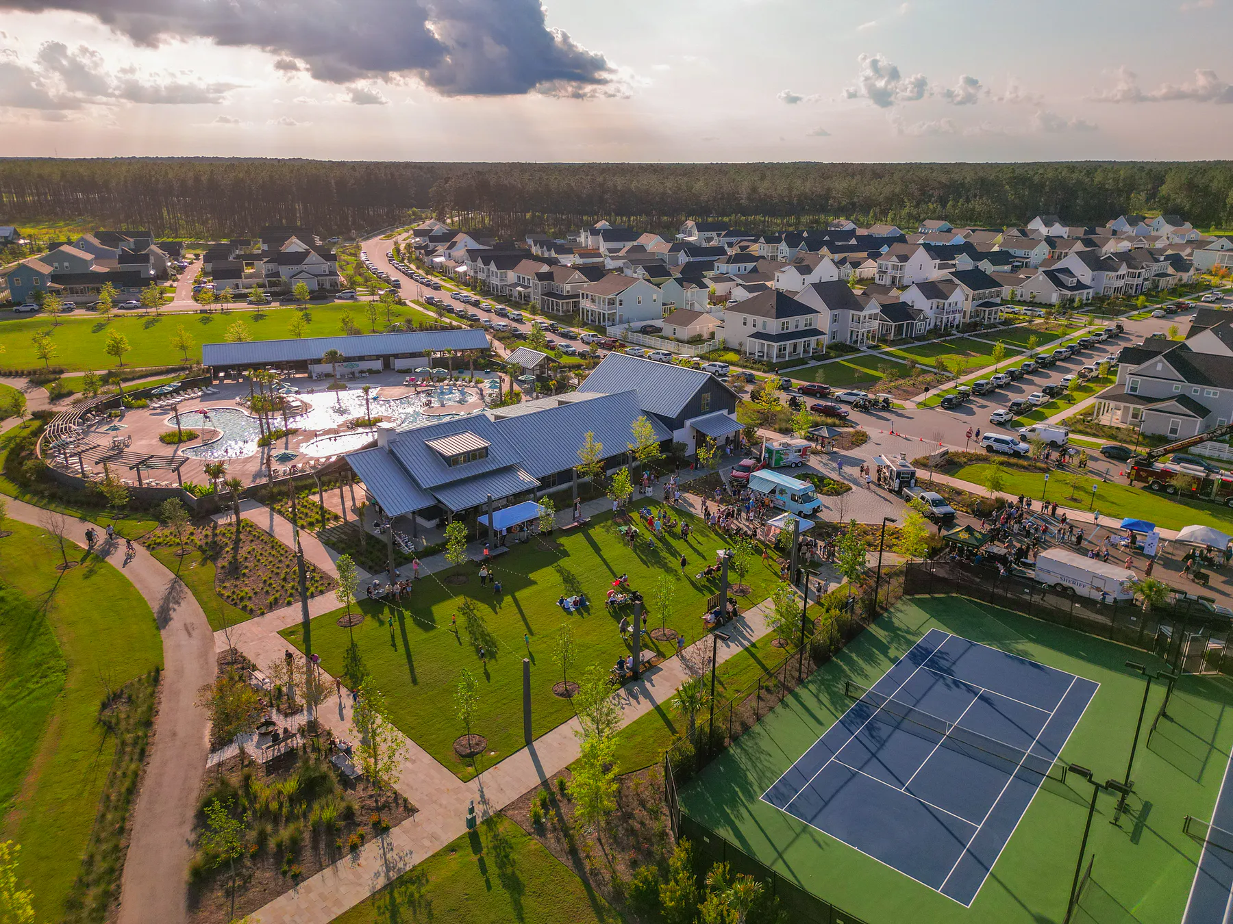 Aerial view of Nexton homes, a clubhouse, pool, lawn, trails and courts