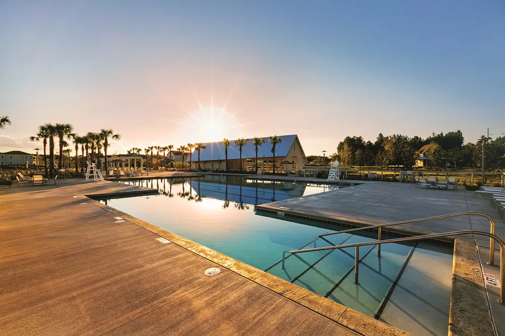Brighton Park Swim Club pool and amenity building at sunset